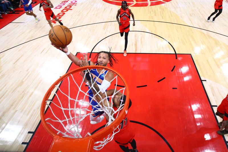 TORONTO, CANADA - MARCH 27: Jalen Brunson #11 of the New York Knicks drives to the basket during the game against the Toronto Raptors on March 27, 2024 at the Scotiabank Arena in Toronto, Ontario, Canada.  NOTE TO USER: User expressly acknowledges and agrees that, by downloading and or using this Photograph, user is consenting to the terms and conditions of the Getty Images License Agreement.  Mandatory Copyright Notice: Copyright 2024 NBAE (Photo by Vaughn Ridley/NBAE via Getty Images)