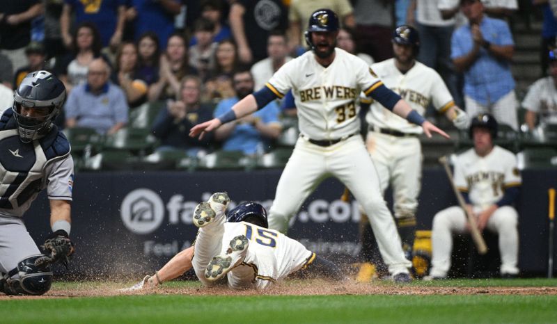 May 23, 2023; Milwaukee, Wisconsin, USA; Milwaukee Brewers center fielder Tyrone Taylor (15) slides home safely against the Houston Astros at American Family Field. Mandatory Credit: Michael McLoone-USA TODAY Sports