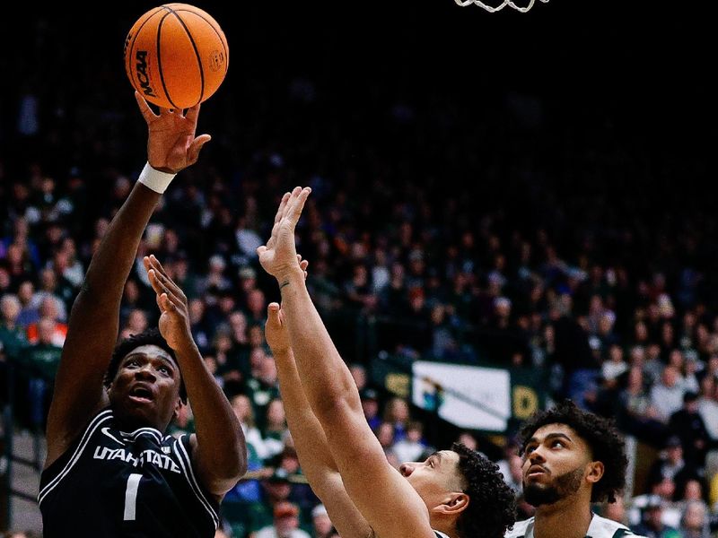 Feb 17, 2024; Fort Collins, Colorado, USA; Utah State Aggies forward Great Osobor (1) attempts a shot against Colorado State Rams forward Joel Scott (1) as guard Rashaan Mbemba (21) defends in the first half at Moby Arena. Mandatory Credit: Isaiah J. Downing-USA TODAY Sports