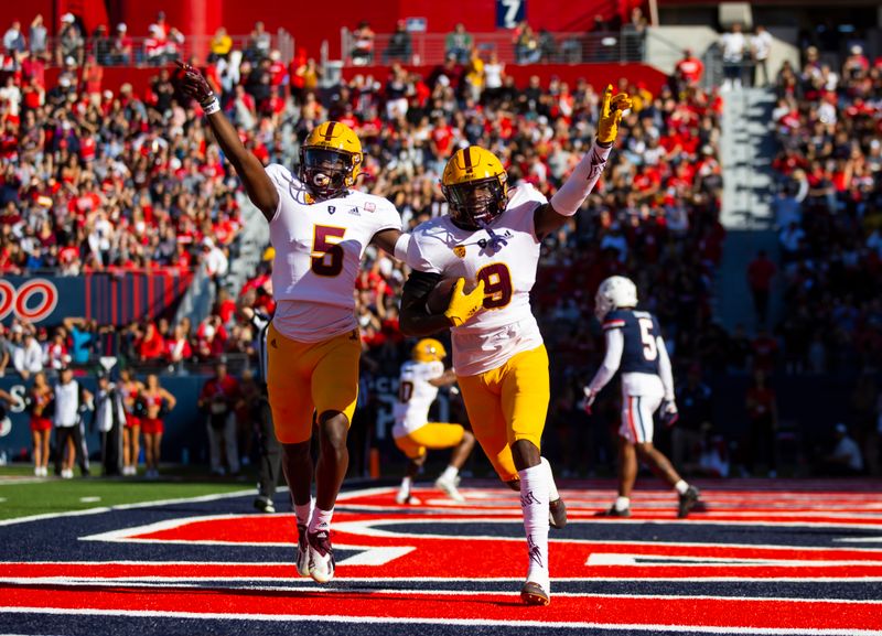 Nov 25, 2022; Tucson, Arizona, USA; Arizona State Sun Devils defensive back Ro Torrence (9) celebrates his interception with teammate Chris Edmonds (5) against the Arizona Wildcats in the first half of the Territorial Cup at Arizona Stadium. Mandatory Credit: Mark J. Rebilas-USA TODAY Sports