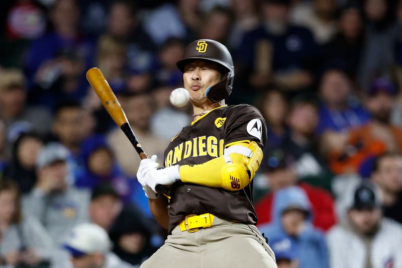 May 6, 2024; Chicago, Illinois, USA; San Diego Padres shortstop Ha-Seong Kim (7) is hit by a pitch from Chicago Cubs relief pitcher Richard Lovelady (not pictured) during the sixth inning at Wrigley Field. Mandatory Credit: Kamil Krzaczynski-USA TODAY Sports