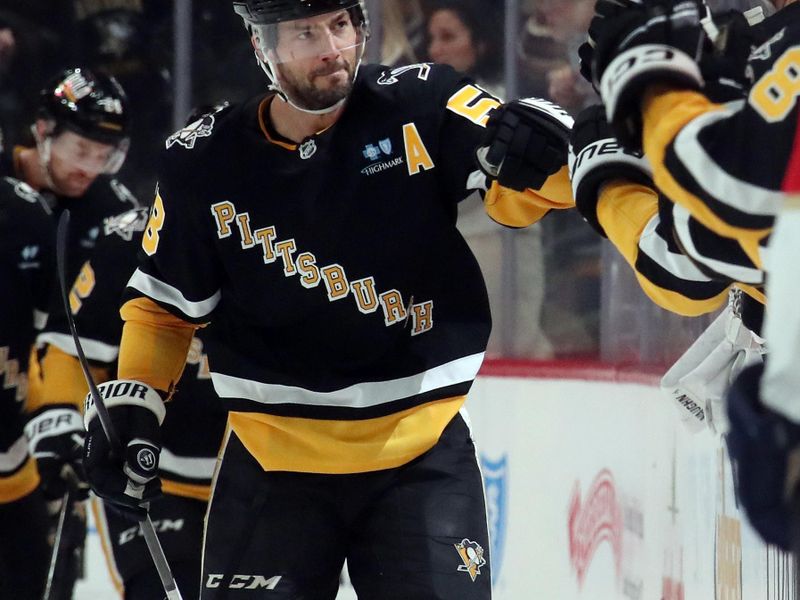 Dec 3, 2024; Pittsburgh, Pennsylvania, USA;  Pittsburgh Penguins defenseman Kris Letang (58) celebrates his goal with the bench against the Florida Panthers during the second period at PPG Paints Arena. Mandatory Credit: Charles LeClaire-Imagn Images