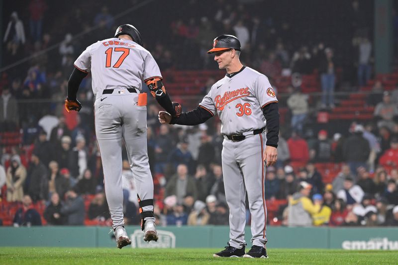 Apr 11, 20024; Boston, Massachusetts, USA; Baltimore Orioles left fielder Colton Cowser (17) celebrates a home run with third baseman coach Tony Mansolino (36) during the tenth inning against the Boston Red Sox at Fenway Park. Mandatory Credit: Eric Canha-USA TODAY Sports