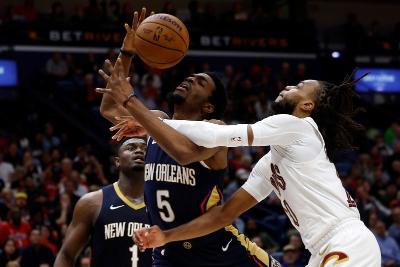 NEW ORLEANS, LOUISIANA - MARCH 13: Herbert Jones #5 of the New Orleans Pelicans shoots the ball over Darius Garland #10 of the Cleveland Cavaliers at Smoothie King Center on March 13, 2024 in New Orleans, Louisiana.   NOTE TO USER: User expressly acknowledges and agrees that, by downloading and or using this photograph, User is consenting to the terms and conditions of the Getty Images License Agreement.  (Photo by Chris Graythen/Getty Images)