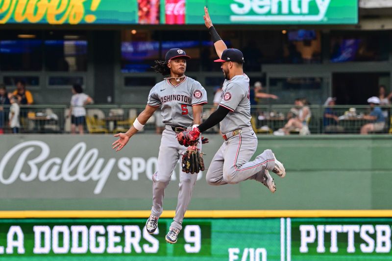 Jul 13, 2024; Milwaukee, Wisconsin, USA; Washington Nationals shortstop C.J. Abrams (5) celebrates with second baseman Luis Garcia (2) after beating the Milwaukee Brewers at American Family Field. Mandatory Credit: Benny Sieu-USA TODAY Sports