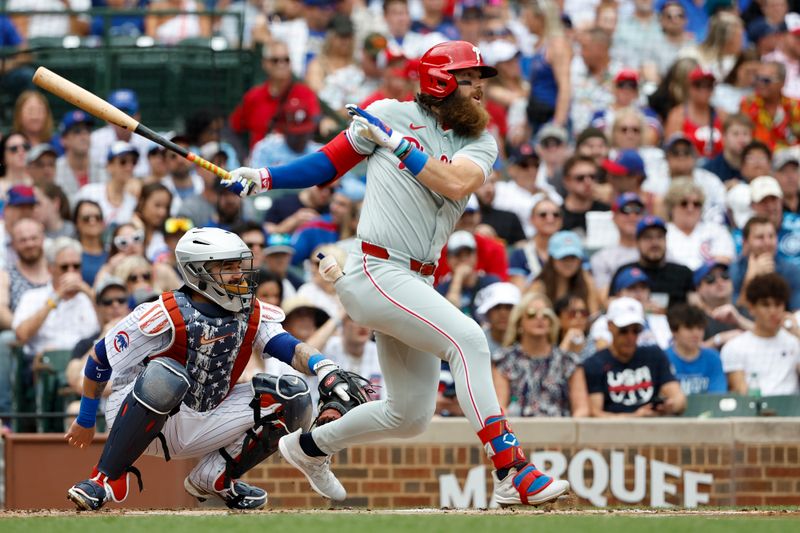 Jul 4, 2024; Chicago, Illinois, USA; Philadelphia Phillies outfielder Brandon Marsh (16) hits an RBI-single against the Chicago Cubs during the first inning at Wrigley Field. Mandatory Credit: Kamil Krzaczynski-USA TODAY Sports