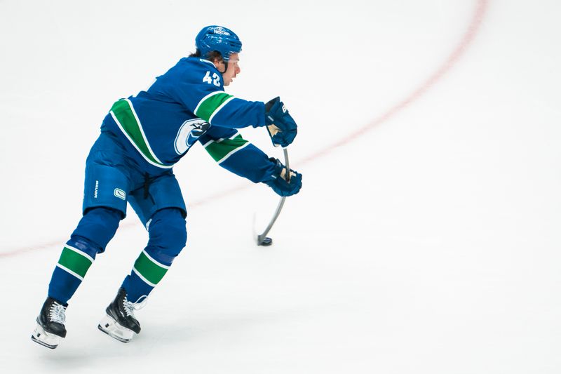 Oct 13, 2025; Vancouver, British Columbia, CAN; Vancouver Canucks defenseman Quinn Hughes (43) makes a pass during warm up prior to a game against the St. Louis Blues at Rogers Arena. Mandatory Credit: Bob Frid-Imagn Images