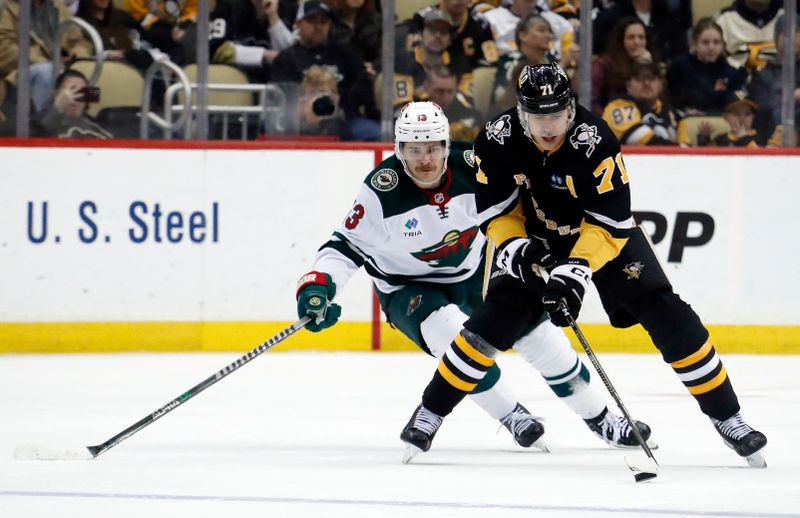 Apr 6, 2023; Pittsburgh, Pennsylvania, USA; Pittsburgh Penguins center Evgeni Malkin (71) skates with the puck against Minnesota Wild center Sam Steel (13) during the third period at PPG Paints Arena. Pittsburgh won 4-1. Mandatory Credit: Charles LeClaire-USA TODAY Sports