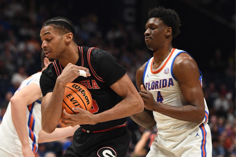 Mar 14, 2024; Nashville, TN, USA; Georgia Bulldogs center Frank Anselem-Ibe (5) grabs a rebound during the first half against Florida Gators forward Tyrese Samuel (4) at Bridgestone Arena. Mandatory Credit: Christopher Hanewinckel-USA TODAY Sports