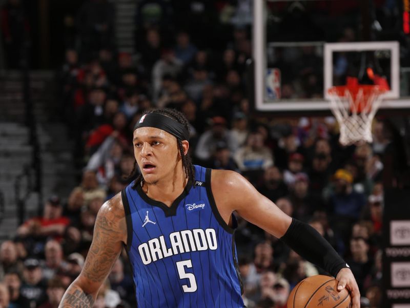 PORTLAND, OR - JANUARY 30:   Paolo Banchero #5 of the Orlando Magic dribbles the ball during the game against the Portland Trail Blazers on January 30, 2025 at the Moda Center Arena in Portland, Oregon. NOTE TO USER: User expressly acknowledges and agrees that, by downloading and or using this photograph, user is consenting to the terms and conditions of the Getty Images License Agreement. Mandatory Copyright Notice: Copyright 2025 NBAE (Photo by Cameron Browne/NBAE via Getty Images)