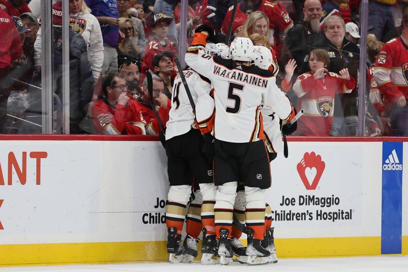 Jan 15, 2024; Sunrise, Florida, USA; Anaheim Ducks defenseman Urho Vaakanainen (5) celebrates with teammates after left wing Alex Killorn (17) scored the game-winning goal against the Florida Panthers during overtime at Amerant Bank Arena. Mandatory Credit: Sam Navarro-USA TODAY Sports