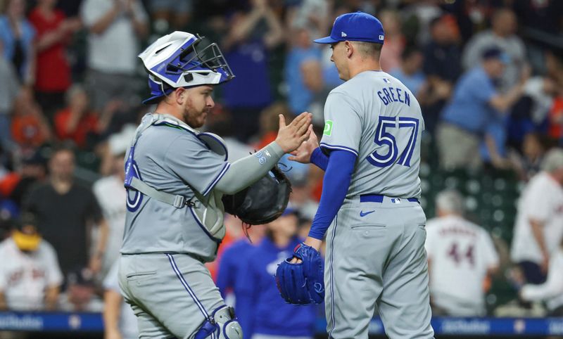 Apr 2, 2024; Houston, Texas, USA; Toronto Blue Jays relief pitcher Chad Green (57) celebrates with catcher Alejandro Kirk (30) after the game against the Houston Astros at Minute Maid Park. Mandatory Credit: Troy Taormina-USA TODAY Sports