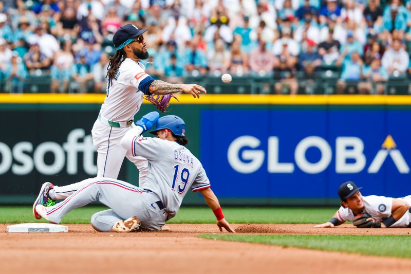 Aug 2, 2025; Seattle, Washington, USA; Seattle Mariners shortstop J.P. Crawford (3) turns a double play against Texas Rangers left fielder Alejandro Osuna (19) during the fifth inning at T-Mobile Park. Mandatory Credit: Joe Nicholson-Imagn Images
