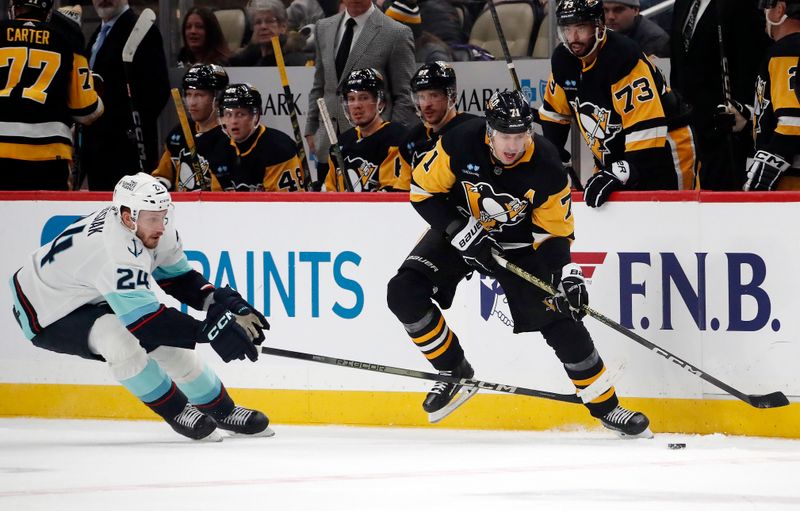 Jan 15, 2024; Pittsburgh, Pennsylvania, USA; Pittsburgh Penguins center Evgeni Malkin (71) moves the puck against Seattle Kraken defenseman Jamie Oleksiak (24) during the second period at PPG Paints Arena. Mandatory Credit: Charles LeClaire-USA TODAY Sports