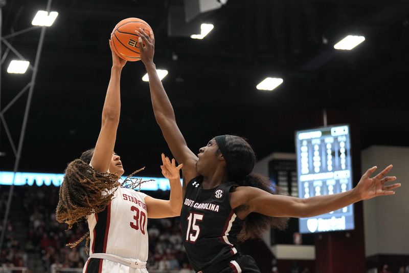 Nov 20, 2022; Stanford, California, USA; South Carolina Gamecocks forward Laeticia Amihere (15) blocks a shot by Stanford Cardinal guard Haley Jones (30) during the fourth quarter at Maples Pavilion. Mandatory Credit: Darren Yamashita-USA TODAY Sports