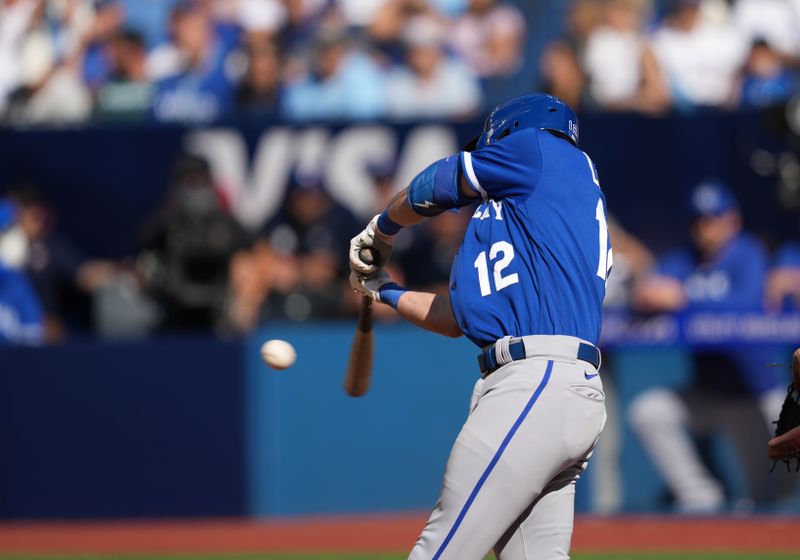 Sep 10, 2023; Toronto, Ontario, CAN; Kansas City Royals first baseman Nick Loftin (12) hits a double against the Toronto Blue Jays during the ninth inning at Rogers Centre. Mandatory Credit: Nick Turchiaro-USA TODAY Sports