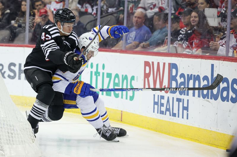 Oct 27, 2023; Newark, New Jersey, USA; New Jersey Devils center Curtis Lazar (42) battles for the puck against Buffalo Sabres defenseman Mattias Samuelsson (23) during the first period  at Prudential Center. Mandatory Credit: Vincent Carchietta-USA TODAY Sports