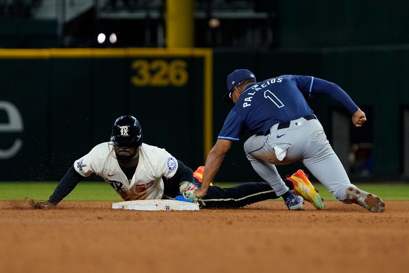 Jul 5, 2024; Arlington, Texas, USA; Texas Rangers outfielder Adolis García (53) is tagged out by Tampa Bay Rays second baseman Richie Palacios (1) attempting to steal second base during the eighth inning at Globe Life Field. Mandatory Credit: Raymond Carlin III-USA TODAY Sports