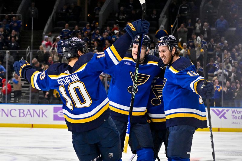 Dec 12, 2023; St. Louis, Missouri, USA;  St. Louis Blues right wing Kevin Hayes (12) is congraty7lated by defenseman Colton Parayko (55) and center Brayden Schenn (10) after scoring his second goal of the game against the Detroit Red Wings during the second period at Enterprise Center. Mandatory Credit: Jeff Curry-USA TODAY Sports