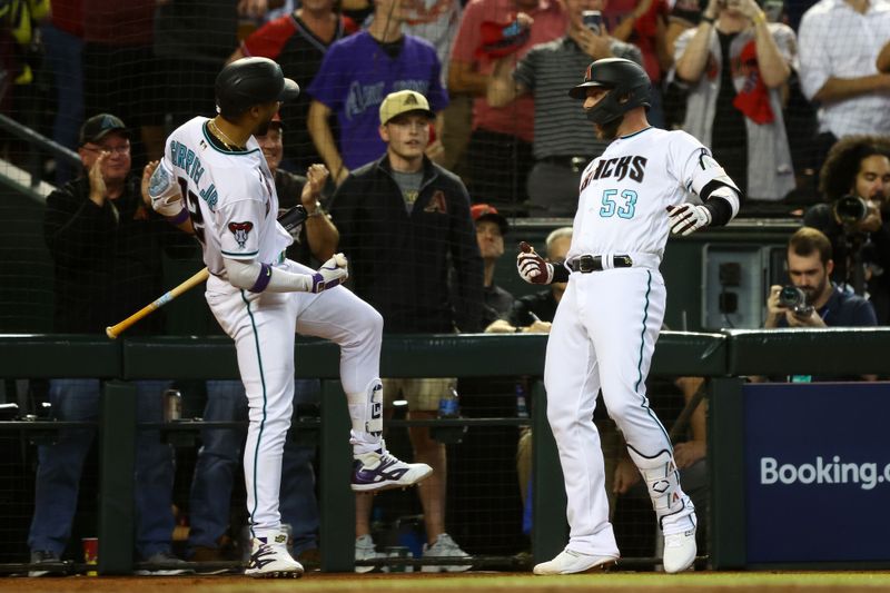 Oct 11, 2023; Phoenix, Arizona, USA; Arizona Diamondbacks first baseman Christian Walker (53) reacts with left fielder Lourdes Gurriel Jr. (12) after hitting a home run against the Los Angeles Dodgers in the third inning for game three of the NLDS for the 2023 MLB playoffs at Chase Field. Mandatory Credit: Mark J. Rebilas-USA TODAY Sports