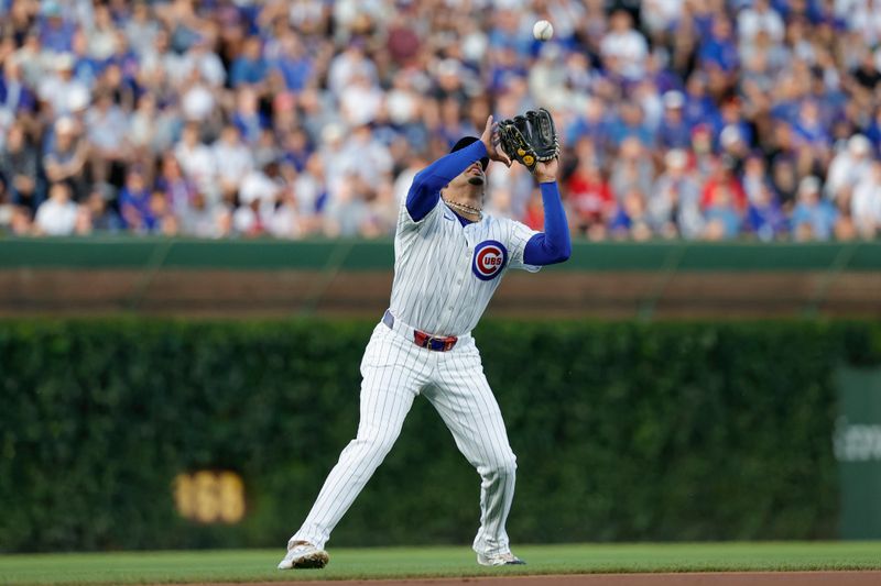 Jul 2, 2024; Chicago, Illinois, USA; Chicago Cubs third baseman Christopher Morel (5) catches a flyt ball hit by Philadelphia Phillies second baseman Bryson Stott during the first inning at Wrigley Field. Mandatory Credit: Kamil Krzaczynski-USA TODAY Sports