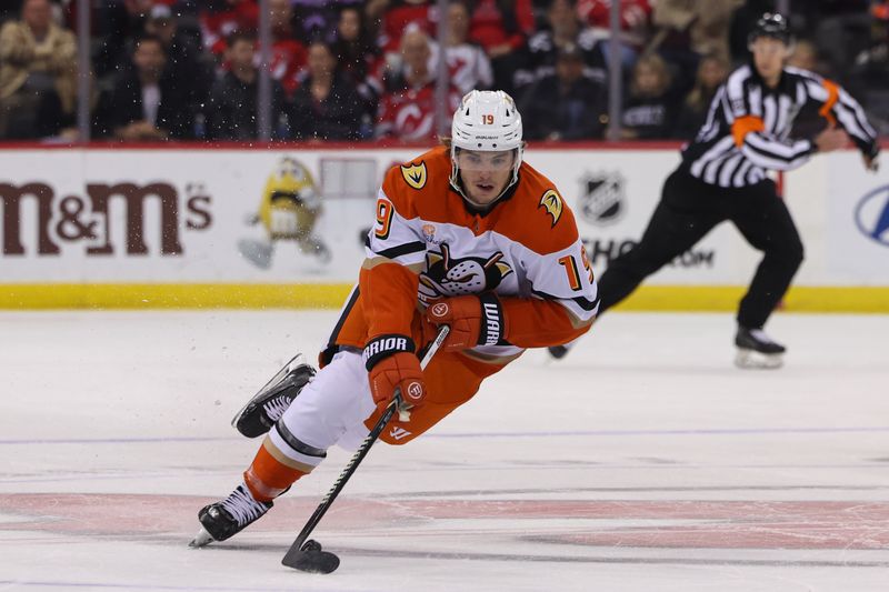 Oct 27, 2024; Newark, New Jersey, USA; Anaheim Ducks right wing Troy Terry (19) skates with the puck against the New Jersey Devils during the first period at Prudential Center. Mandatory Credit: Ed Mulholland-Imagn Images