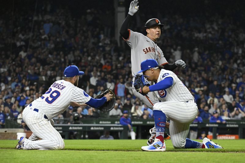 May 6, 2025; Chicago, Illinois, USA;  San Francisco Giants first base Wilmer Flores (41) runs between Chicago Cubs pitcher Daniel Palencia (48) and first baseman Michael Busch (29) during the eighth inning at Wrigley Field. Mandatory Credit: Matt Marton-Imagn Images