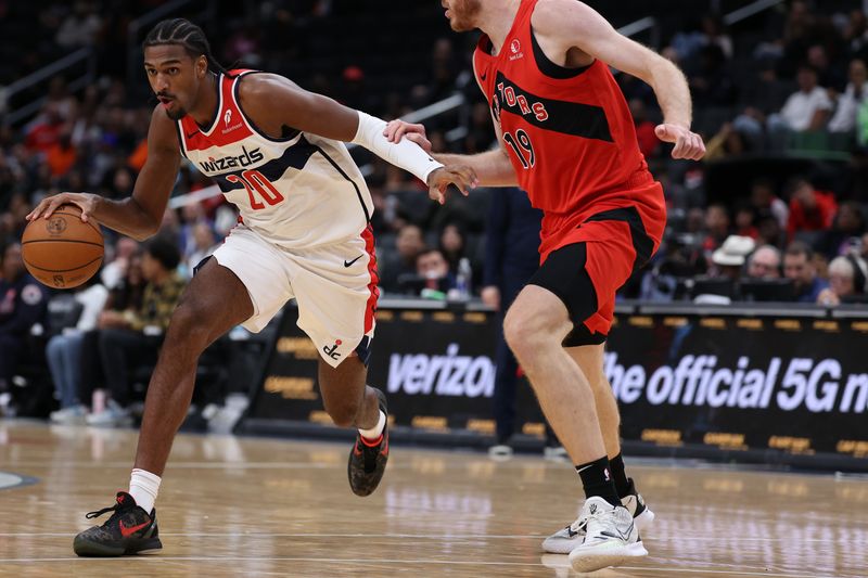 WASHINGTON, DC - OCTOBER 11: Alex Sarr #20 of the Washington Wizards dribbles the ball against the Toronto Raptors during the first half of a preseason game at Capital One Arena on October 11, 2024 in Washington, DC. NOTE TO USER: User expressly acknowledges and agrees that, by downloading and or using this photograph, User is consenting to the terms and conditions of the Getty Images License Agreement. (Photo by Patrick Smith/Getty Images)