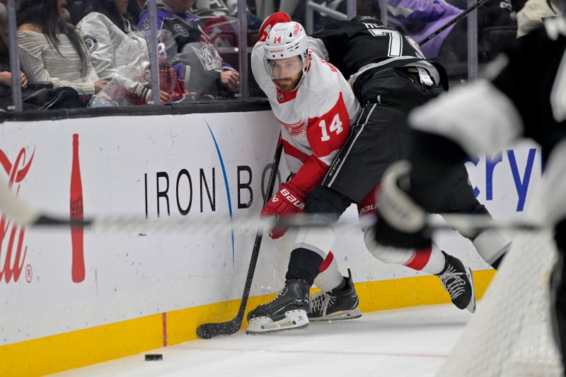 Nov 16, 2024; Los Angeles, California, USA; Detroit Red Wings right wing Christian Fischer (36) and Los Angeles Kings Jacob Moverare (43) and center Samuel Heleniux (79) go for the puck in the first period at Crypto.com Arena. Mandatory Credit: Jayne Kamin-Oncea-Imagn Images