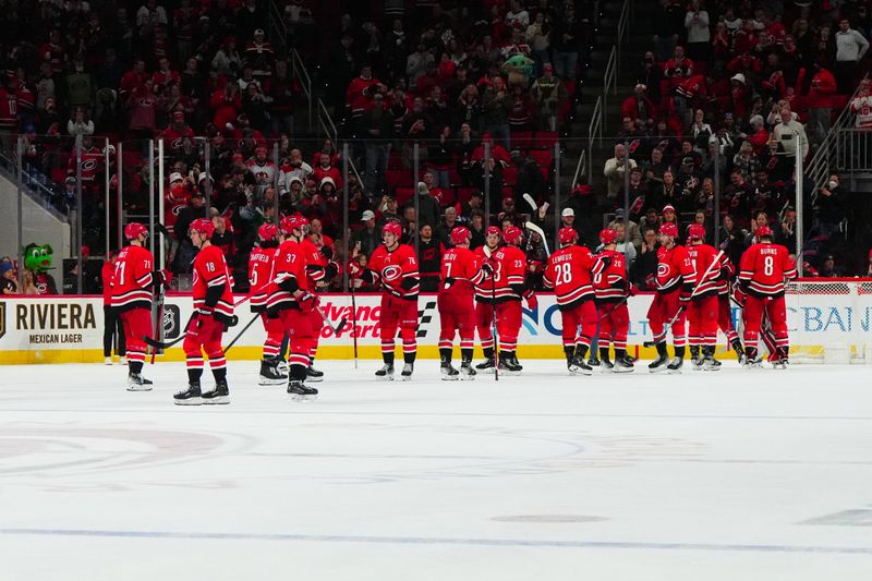 Jan 11, 2024; Raleigh, North Carolina, USA; Carolina Hurricanes players celebrate their victory against the Anaheim Ducks at PNC Arena. Mandatory Credit: James Guillory-USA TODAY Sports