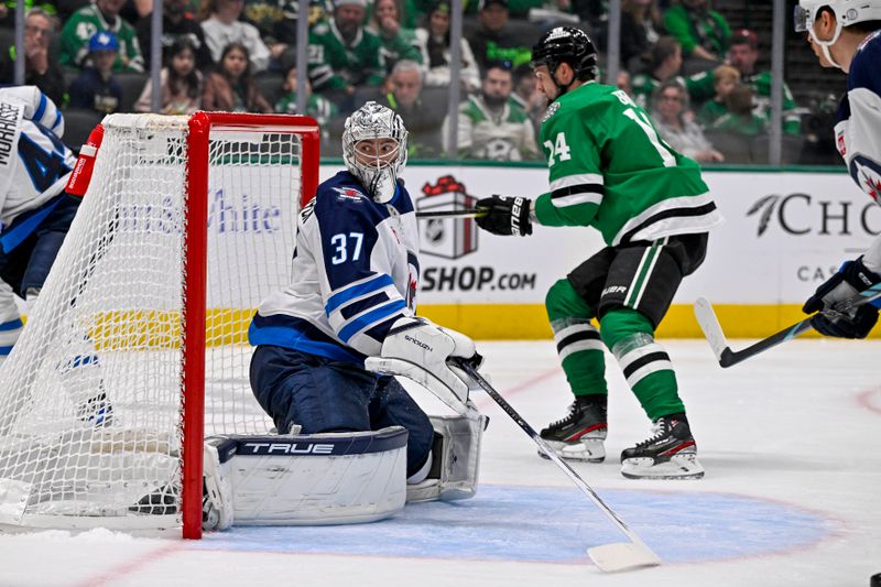 Dec 1, 2024; Dallas, Texas, USA; Winnipeg Jets goaltender Connor Hellebuyck (37) faces the Dallas Stars attack during the second period at the American Airlines Center. Mandatory Credit: Jerome Miron-Imagn Images