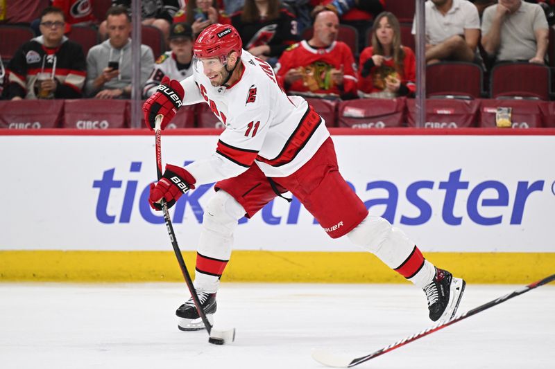 Apr 14, 2024; Chicago, Illinois, USA;  Carolina Hurricanes forward Jordan Staal (11) scores a goal from a shot against the Chicago Blackhawks in the second period at United Center. Mandatory Credit: Jamie Sabau-USA TODAY Sports