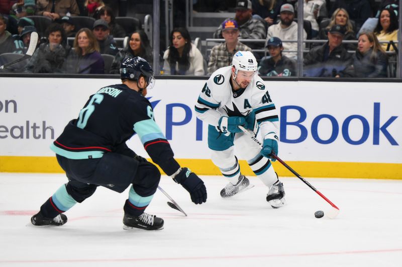 Nov 22, 2023; Seattle, Washington, USA; San Jose Sharks center Tomas Hertl (48) defends the puck from Seattle Kraken defenseman Adam Larsson (6) during the first period at Climate Pledge Arena. Mandatory Credit: Steven Bisig-USA TODAY Sports