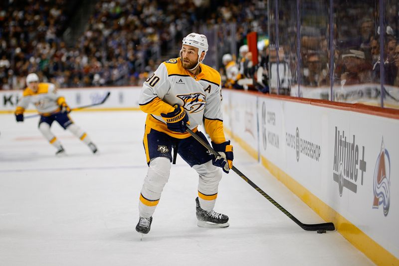 Dec 14, 2024; Denver, Colorado, USA; Nashville Predators center Ryan O'Reilly (90) controls the puck in the first period against the Colorado Avalanche at Ball Arena. Mandatory Credit: Isaiah J. Downing-Imagn Images