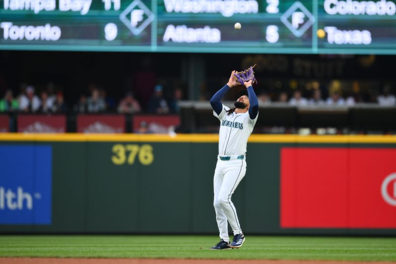 May 13, 2025; Seattle, Washington, USA; Seattle Mariners shortstop J.P. Crawford (3) catches a ball hit by New York Yankees center fielder Trent Grisham (12) (not pictured) during the third inning at T-Mobile Park. Mandatory Credit: Steven Bisig-Imagn Images