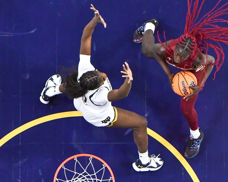 Jan 11, 2024; South Bend, Indiana, USA; Boston College Eagles forward Nene Ndiaye (0) looks to shoot as Notre Dame Fighting Irish forward Becky Obinma (10) defends in the second half at the Purcell Pavilion. Mandatory Credit: Matt Cashore-USA TODAY Sports