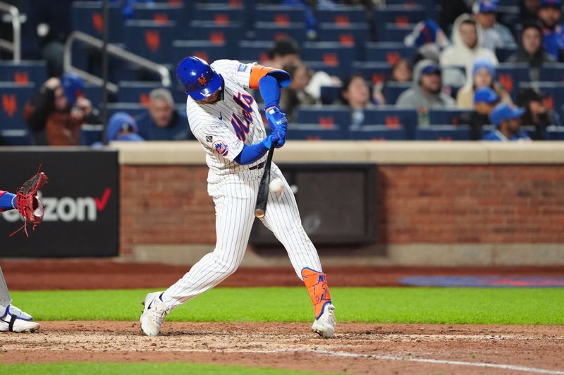 Apr 30, 2024; New York City, New York, USA; New York Mets center fielder Tyrone Taylor (15) hits a single against the Chicago Cubs during the sixth inning at Citi Field. Mandatory Credit: Gregory Fisher-USA TODAY Sports