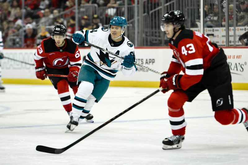 Nov 10, 2024; Newark, New Jersey, USA; San Jose Sharks center Mikael Granlund (64) skates against New Jersey Devils left wing Jesper Bratt (63) and New Jersey Devils defenseman Luke Hughes (43) during the third period at Prudential Center. Mandatory Credit: John Jones-Imagn Images