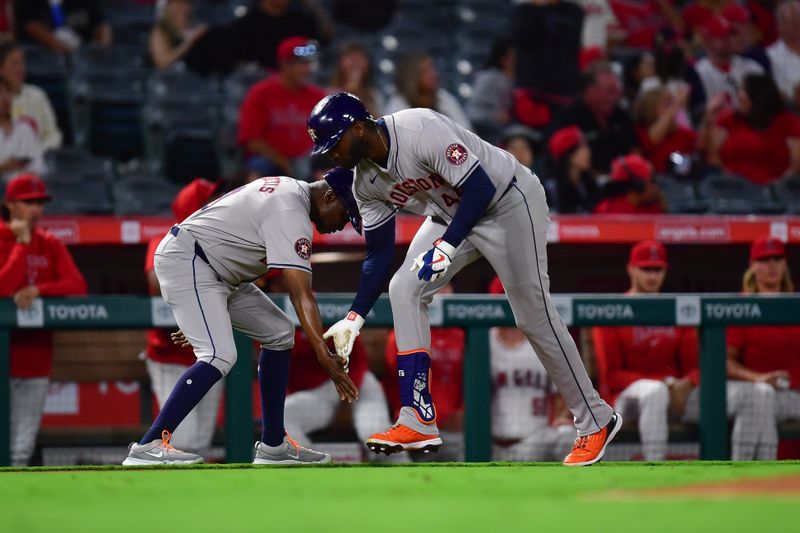 Sep 13, 2024; Anaheim, California, USA; Houston Astros designated hitter Yordan Alvarez (44) is greeted by third base coach Gary Pettis (8) after hitting a solo home run against the Los Angeles Angels during the ninth inning at Angel Stadium. Mandatory Credit: Gary A. Vasquez-Imagn Images