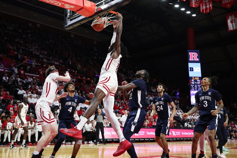 Jan 31, 2024; Piscataway, New Jersey, USA; Rutgers Scarlet Knights center Clifford Omoruyi (11) in front of Penn State Nittany Lions forward Qudus Wahab (22) and forward Puff Johnson (4) during the second half at Jersey Mike's Arena. Mandatory Credit: Vincent Carchietta-USA TODAY Sports