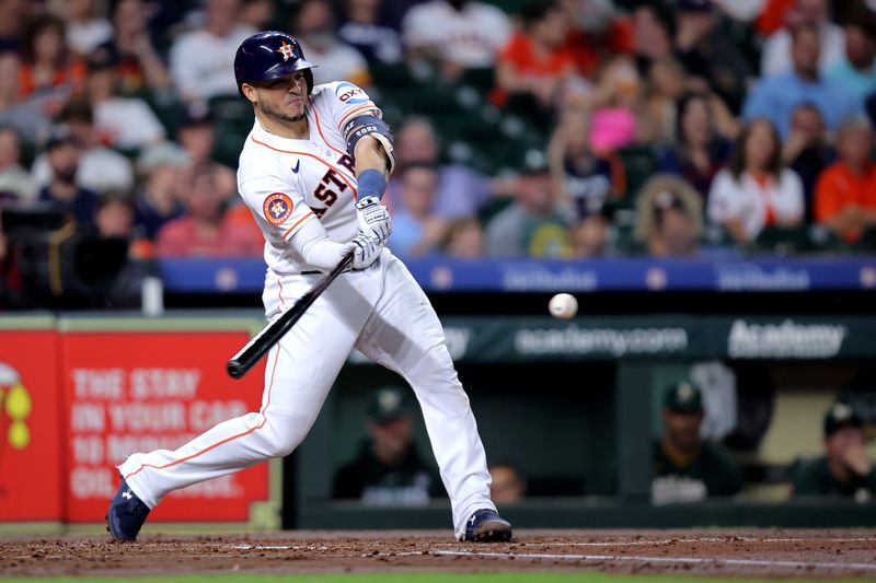 Sep 13, 2023; Houston, Texas, USA; Houston Astros catcher Yainer Diaz (21) hits a single to center field against the Oakland Athletics during the second inning at Minute Maid Park. Mandatory Credit: Erik Williams-USA TODAY Sports