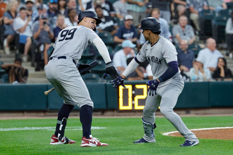 Aug 13, 2024; Chicago, Illinois, USA; New York Yankees outfielder Juan Soto (22) celebrates with outfielder Aaron Judge (99) after hitting a two-run home run against the Chicago White Sox during the third inning at Guaranteed Rate Field. Mandatory Credit: Kamil Krzaczynski-USA TODAY Sports