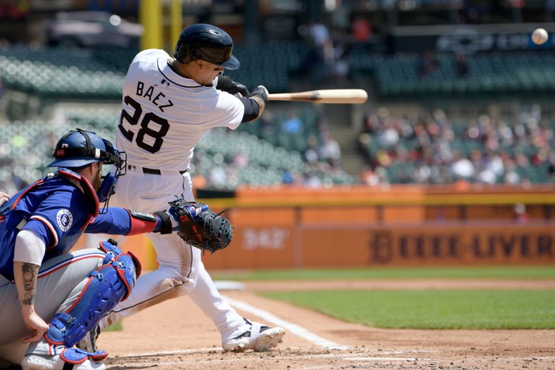 Apr 18, 2024; Detroit, Michigan, USA;  Detroit Tigers shortstop Javier Baez (28) hits a double against the Texas Rangers in the second inning at Comerica Park. Mandatory Credit: Lon Horwedel-USA TODAY Sports