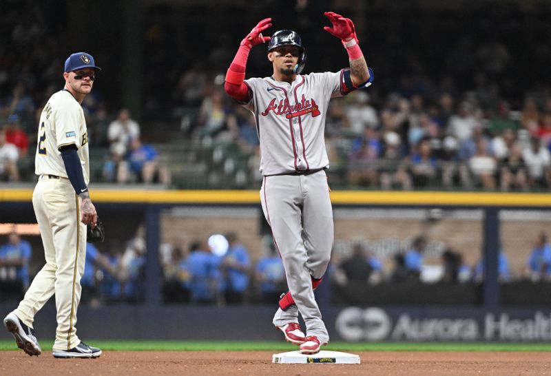 Jul 30, 2024; Milwaukee, Wisconsin, USA; Atlanta Braves shortstop Orlando Arcia (11) celebrates hitting a double agains the Milwaukee Brewers in the sixth inning at American Family Field. Mandatory Credit: Michael McLoone-USA TODAY Sports