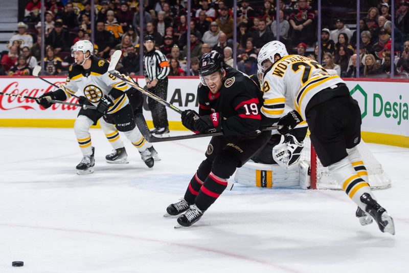 Jan 18, 2025; Ottawa, Ontario, CAN; Ottawa Senators right wing Drake Batherson (19) battles with Boston Bruins defenseman Parker Wotherspoon (29) in the first period at the Canadian Tire Centre. Mandatory Credit: Marc DesRosiers-Imagn Images