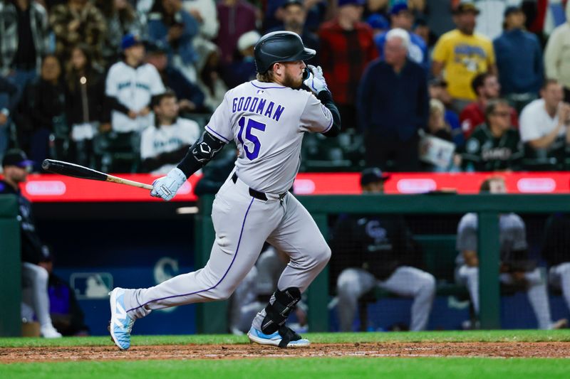 Sep 25, 2025; Seattle, Washington, USA; Colorado Rockies designated hitter Hunter Goodman (15) hits an RBI-single against the Seattle Mariners during the ninth inning at T-Mobile Park. Mandatory Credit: Joe Nicholson-Imagn Images