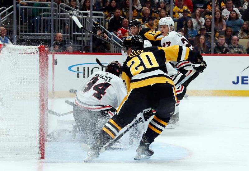 Oct 10, 2023; Pittsburgh, Pennsylvania, USA; Pittsburgh Penguins right wing Bryan Rust (17) scores a goal past Chicago Blackhawks goaltender Petr Mrazek (34) during the first period at the PPG Paints Arena. Mandatory Credit: Charles LeClaire-USA TODAY Sports