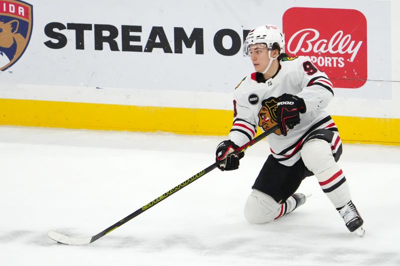 Nov 12, 2023; Sunrise, Florida, USA; Chicago Blackhawks center Connor Bedard (98) plays the puck against the Florida Panthers during the second period at Amerant Bank Arena. Mandatory Credit: Jasen Vinlove-USA TODAY Sports