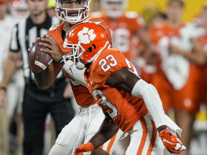 Sep 4, 2021; Charlotte, North Carolina, USA; Clemson Tigers quarterback D.J. Uiagalelei (5) looks for a receiver as running back Lyn-J Dixon (23) blocks against the Georgia Bulldogs during the second half at Bank of America Stadium. Mandatory Credit: Jim Dedmon-USA TODAY Sports