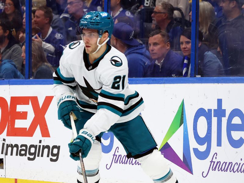 Dec 5, 2024; Tampa, Florida, USA; San Jose Sharks center Alexander Wennberg (21) skates with the puck against the Tampa Bay Lightning during the first period at Amalie Arena. Mandatory Credit: Kim Klement Neitzel-Imagn Images